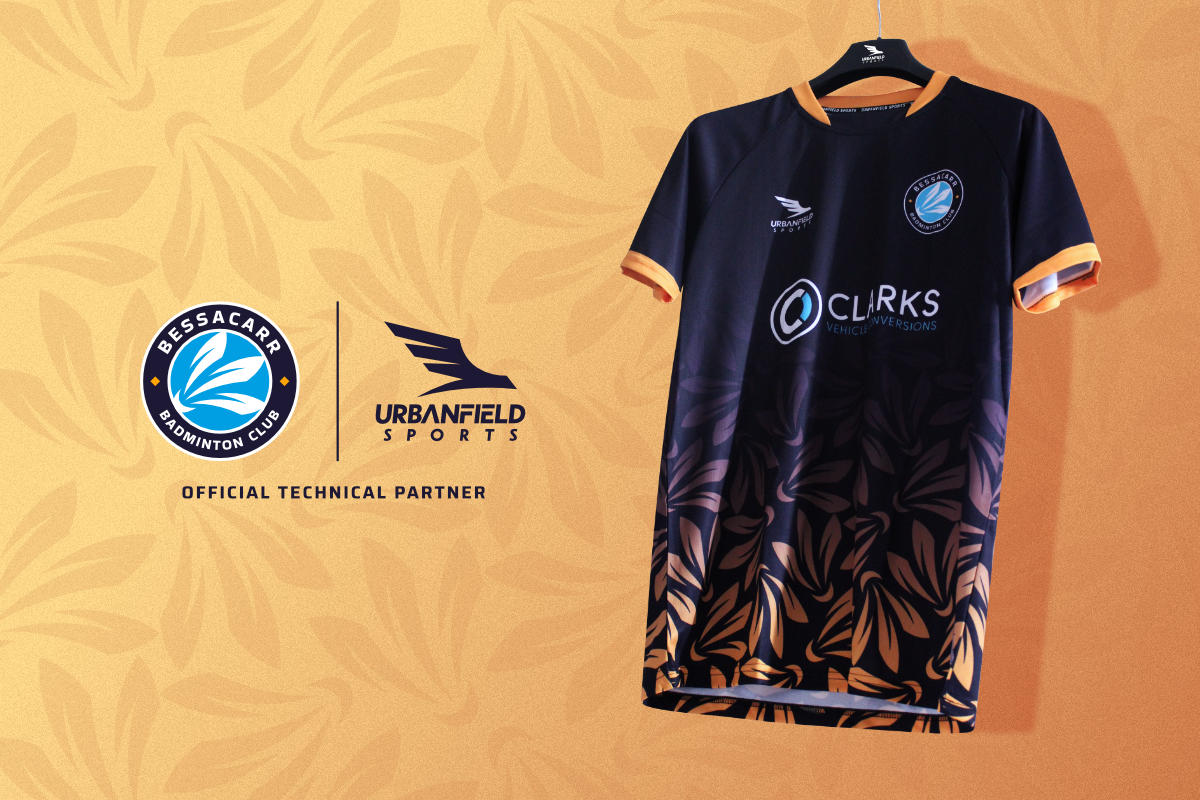 Bessacarr Badminton Club shirt on a black hanger on a yellow background.