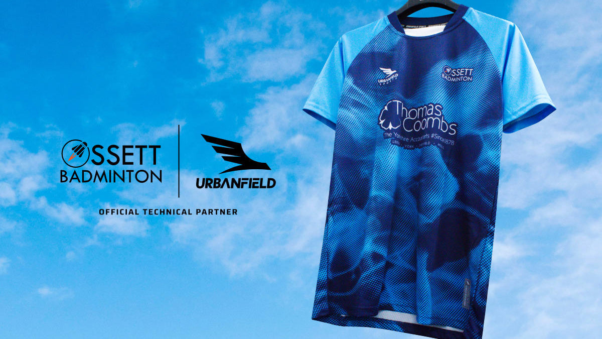 Ossett Badminton Club shirt on a black hanger on a blue sky background.