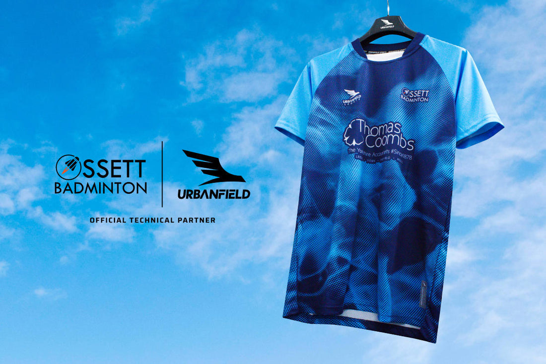 Ossett Badminton Club shirt on a black hanger on a blue sky background.