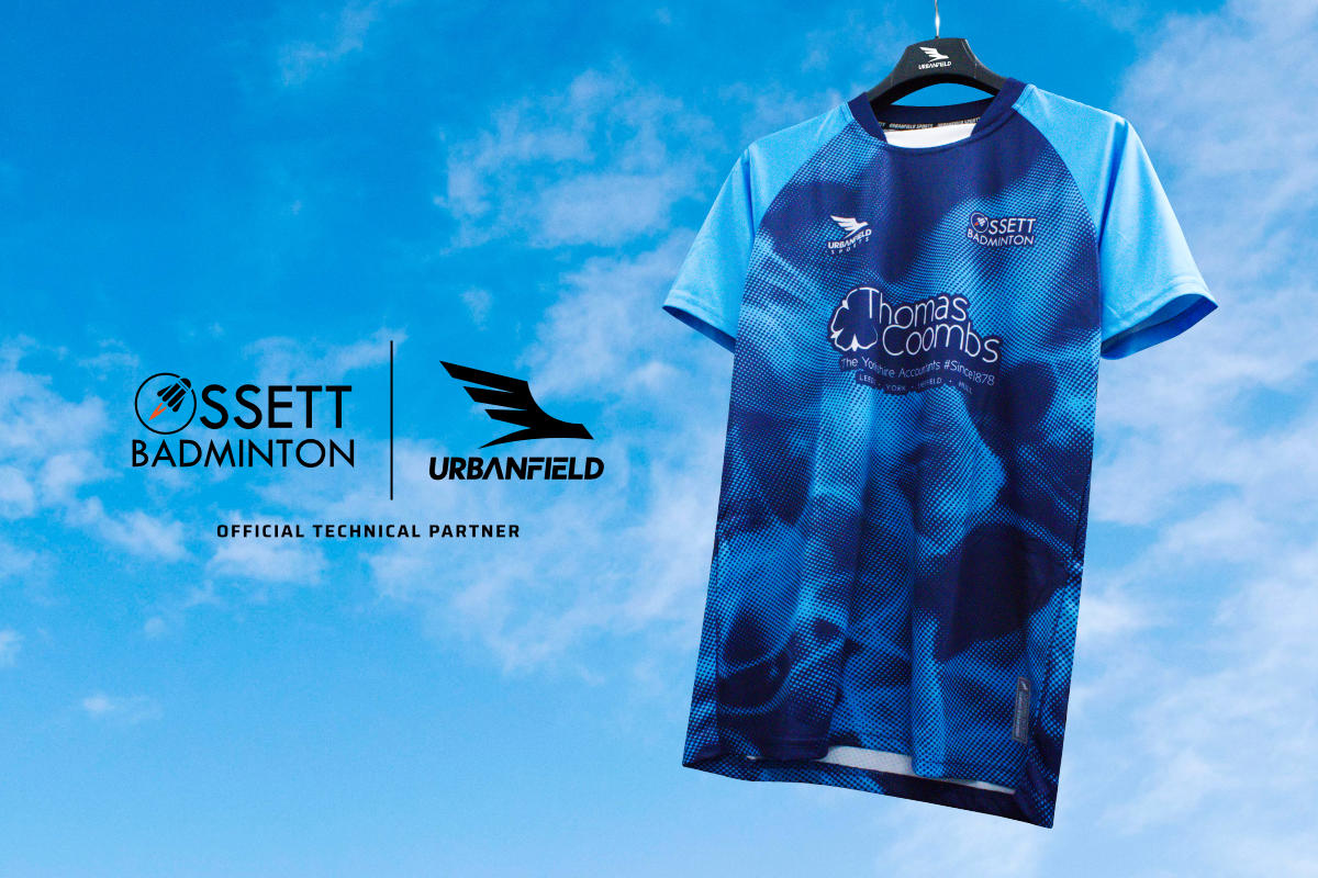 Ossett Badminton Club shirt on a black hanger on a blue sky background.