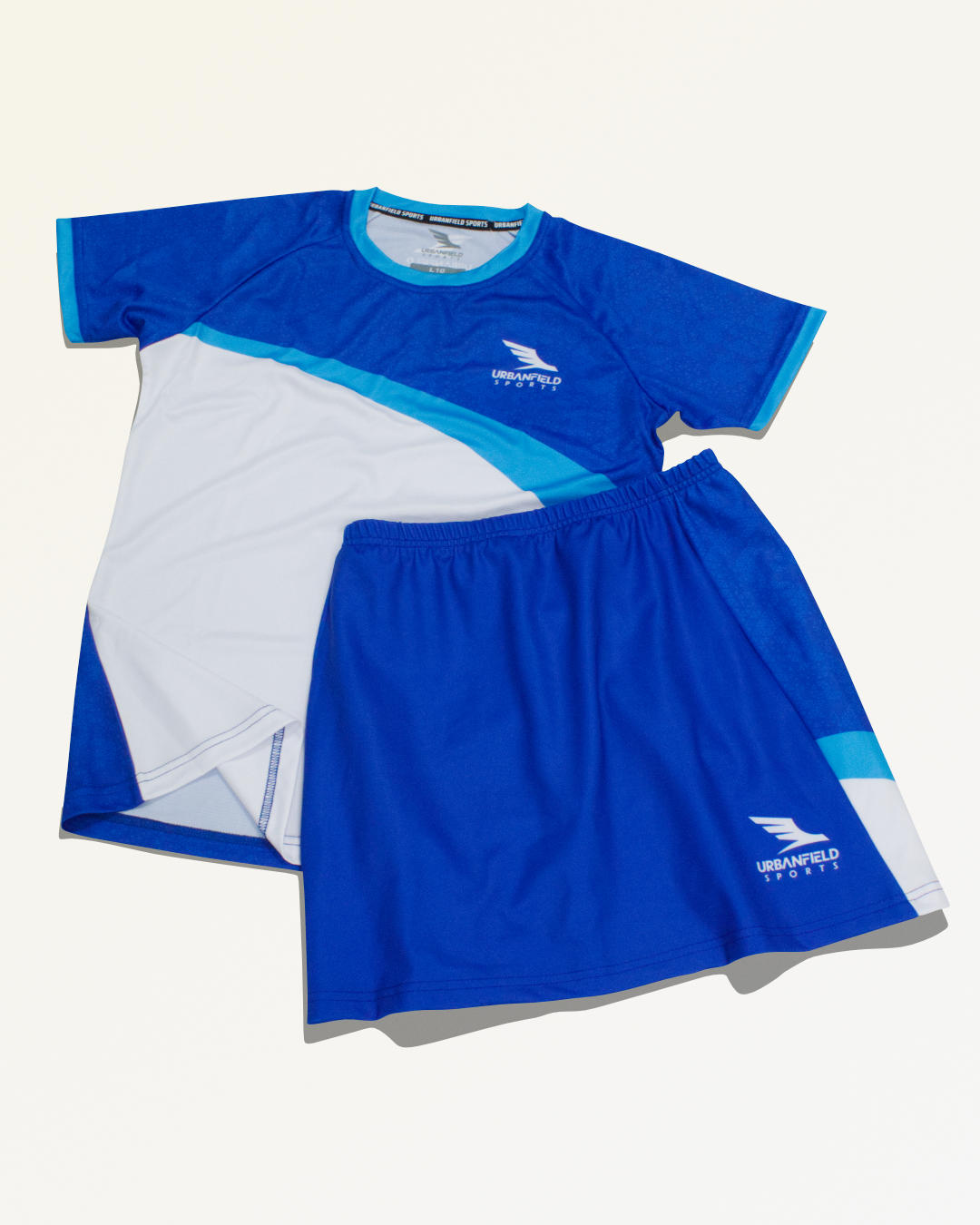 Blue and white Urbanfield Sports outfit on a white background.