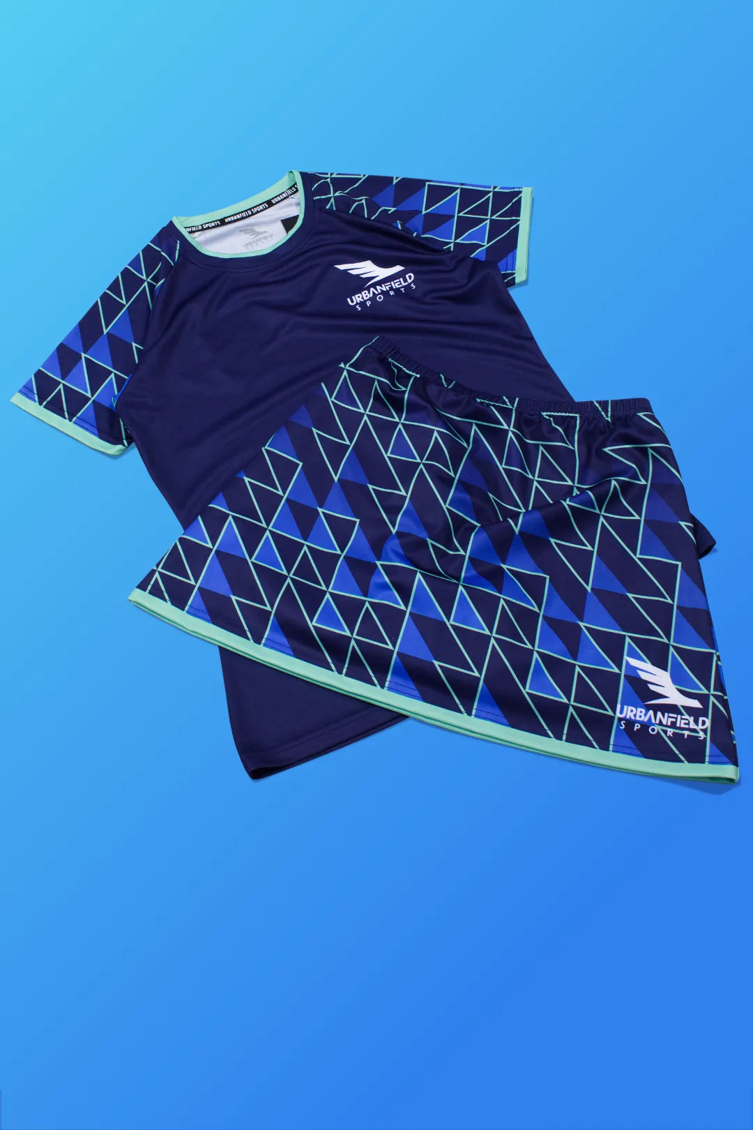 Women's Urbanfield Sports navy blue Tri-I short sleeve t-shirt and matching skort on a light blue background.
