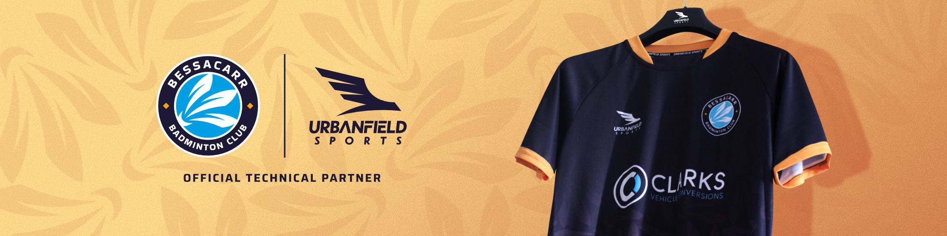 Bessacarr Badminton Club shirt on a black hanger on a yellow background.