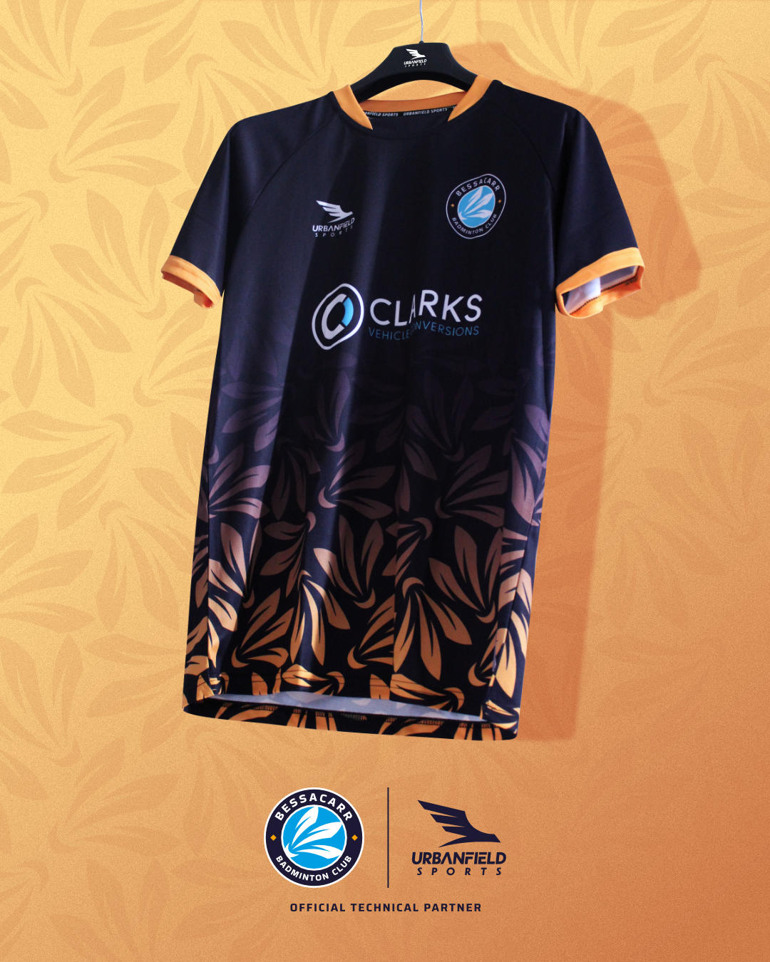 Bessacarr Badminton Club shirt on a black hanger on a yellow background.