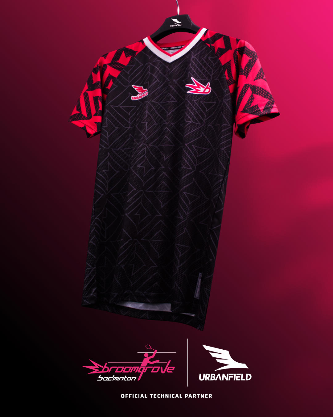 Broomgrove Badminton Club shirt on a black hanger in front of a pink and black background.
