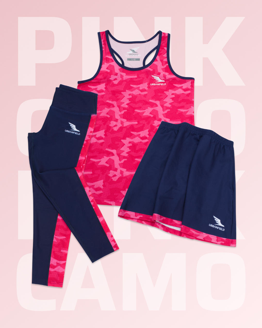 Women's Urbanfield Sports pink and navy camo vest top, skort and leggings in front of a light pink background with 'PINK CAMO' text.