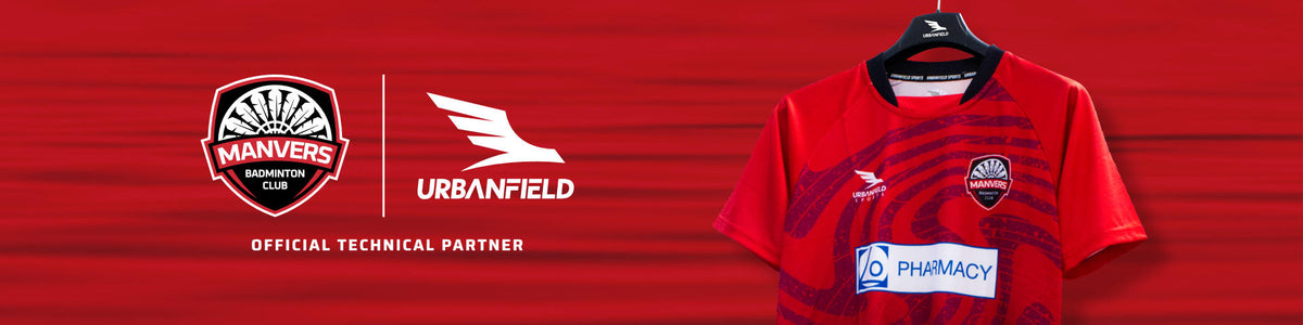 Manvers Badminton Club shirt on a black hanger in front of a red lake background.