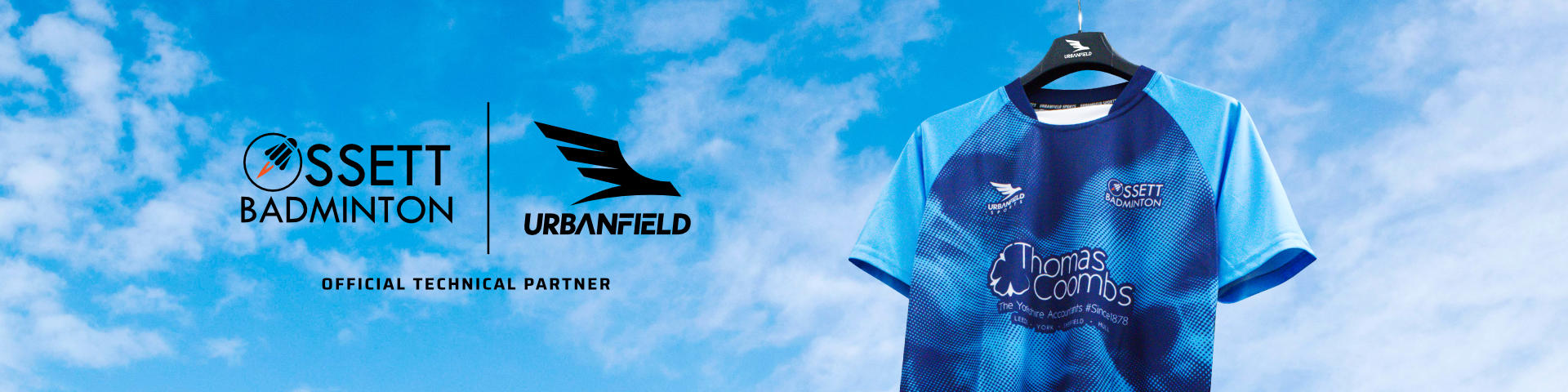 Ossett Badminton Club shirt on a black hanger on a blue sky background.