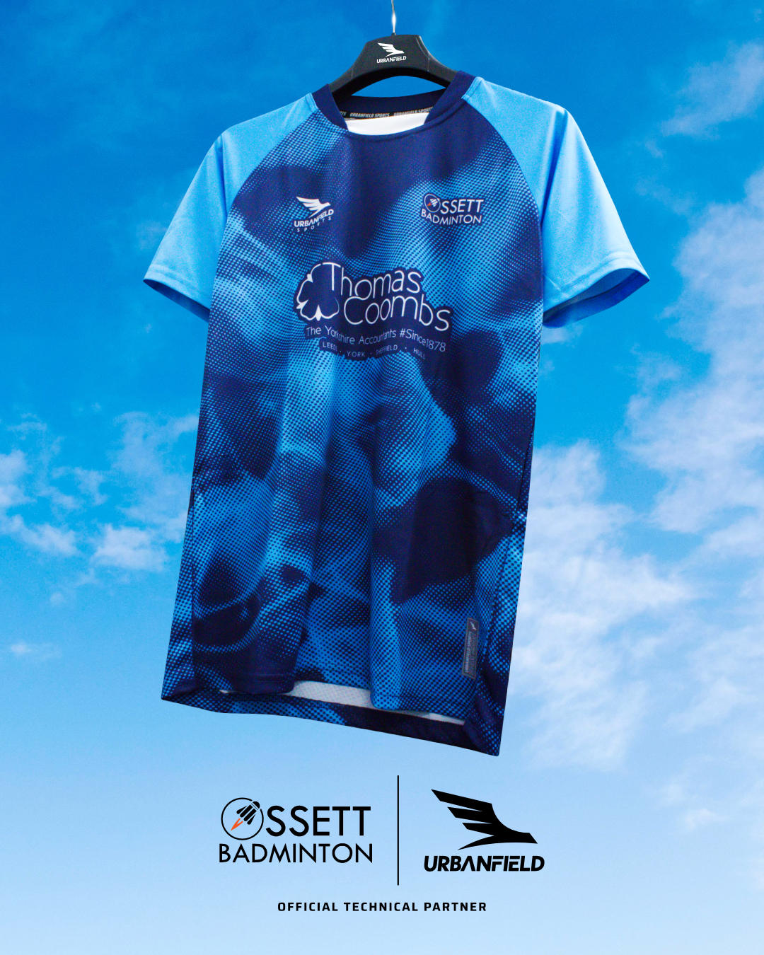 Ossett Badminton Club shirt on a black hanger on a blue sky background.