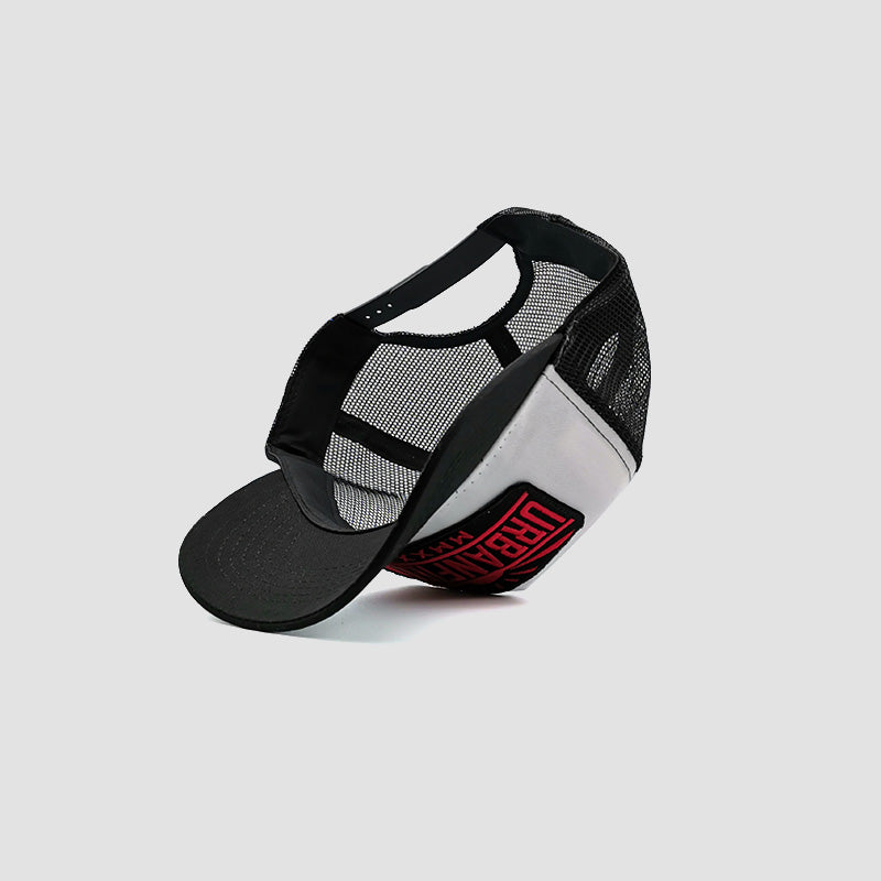 Under side view of Urbanfield Sports sunset trucker cap in black and white