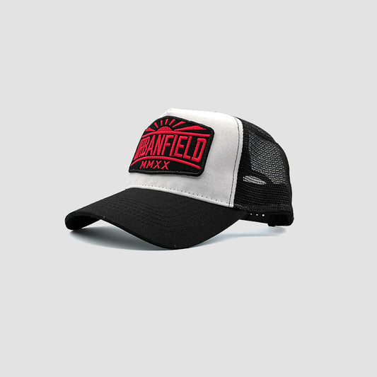 Side view of Urbanfield Sports sunset trucker cap in black and white