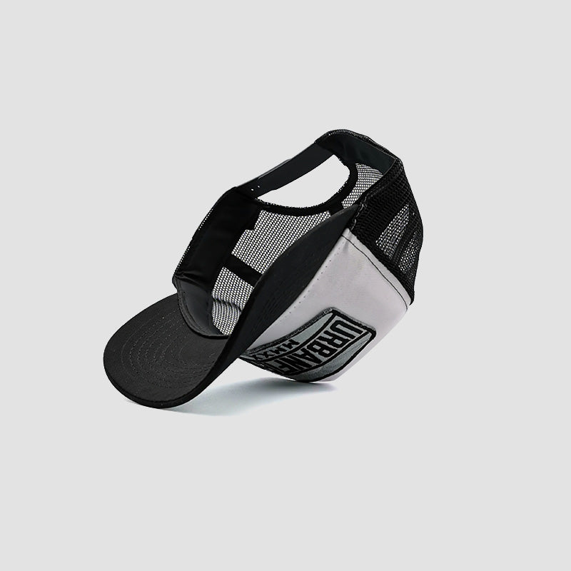 Under side view of Urbanfield Sports sunset trucker cap in black and white