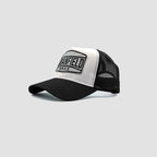 Side view of Urbanfield Sports sunset trucker cap in black and white