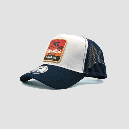 Side view of Urbanfield Sports palm beach trucker cap in navy blue and white