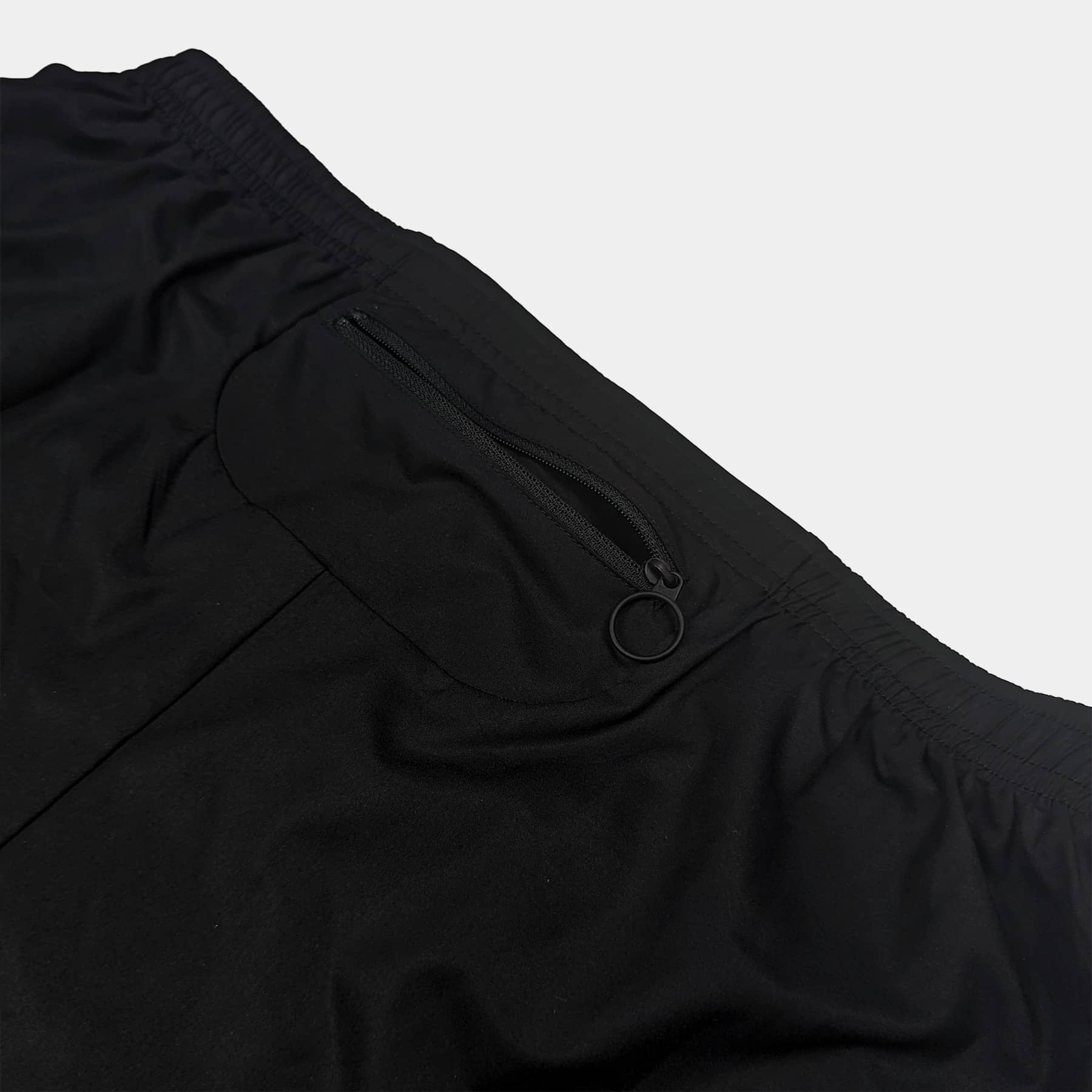 Close up of Urbanfield Sports performance 2-in-1 shorts rear pocket zip